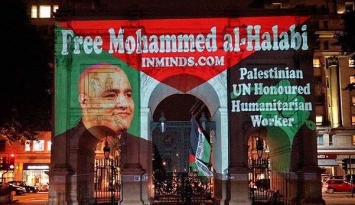 نشطاء يُضيئون جدارية في لندن تضامناً مع الأسير محمد الحلبي