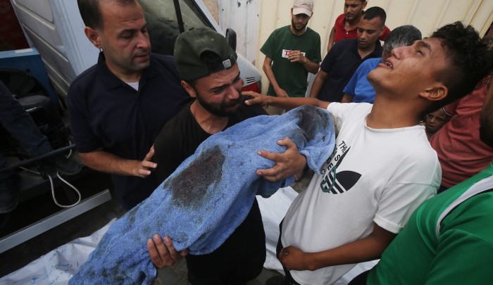 فلسطينيون في مستشفى شهداء الأقصى يبكون طفلاً  قتلته غارة "إسرائيلية"