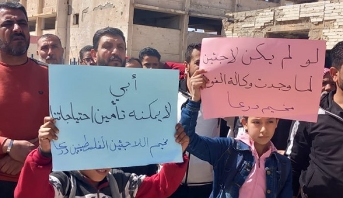 وقفة في مخيم درعا يرفعون لافتات تطالب "أونروا" بتحسين الخدمات خلال وقفة احتجاجية سابقة